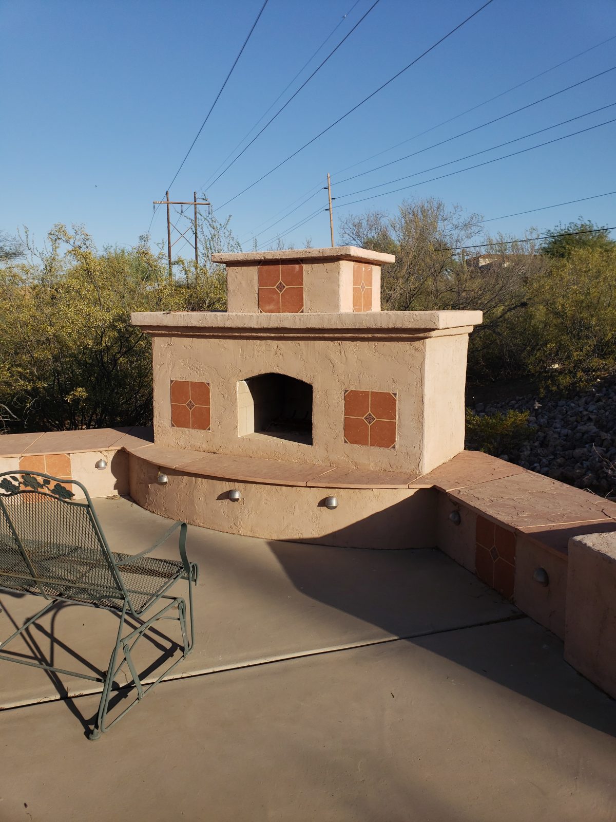 DIY outdoor fireplace with stucco and tile finish