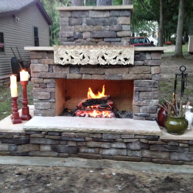 Stone seating on DIY outdoor fireplace