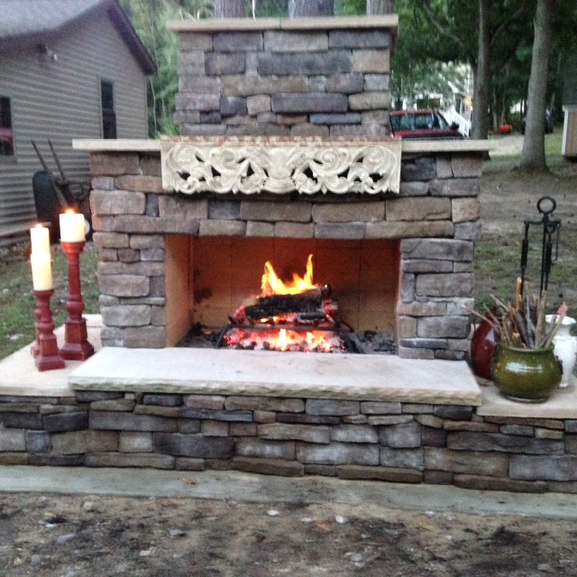 Stone seating on DIY outdoor fireplace