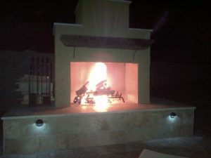 Pima II outdoor fireplace with lights and fire