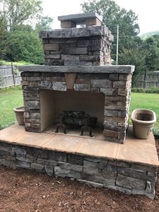 DIY outdoor fireplace planter grass fence mulch chimney hearth fire grate firewood backyard