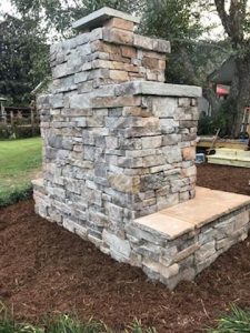 DIY outdoor fireplace veneer backyard patio mulch chimney hearth flagstone grass trees