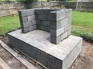 cinderblock concrete slab diy outdoor fireplace grass backyard