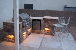 Outdoor kitchen with lighting refrigerator and bar