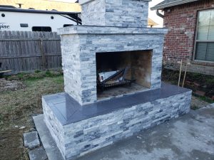 DIY outdoor fireplace with veneer and tile