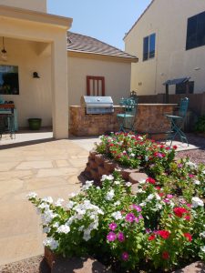 Flagstone patio red door grill kitchen flowers