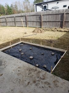 DIY outdoor fireplace concrete pad extension