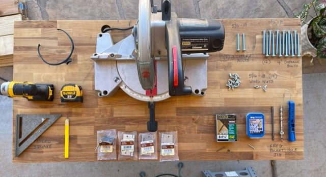 Tools and materials used to build a DIY lemonade stand, hot chocolate stand, beverage bar.  Tools are on a wooden table.